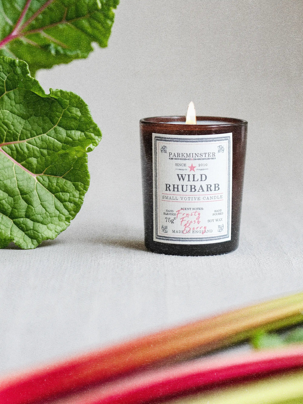 Parkminster Wild Rhubarb hand-poured soy wax votive candle 75g in an amber glass jar