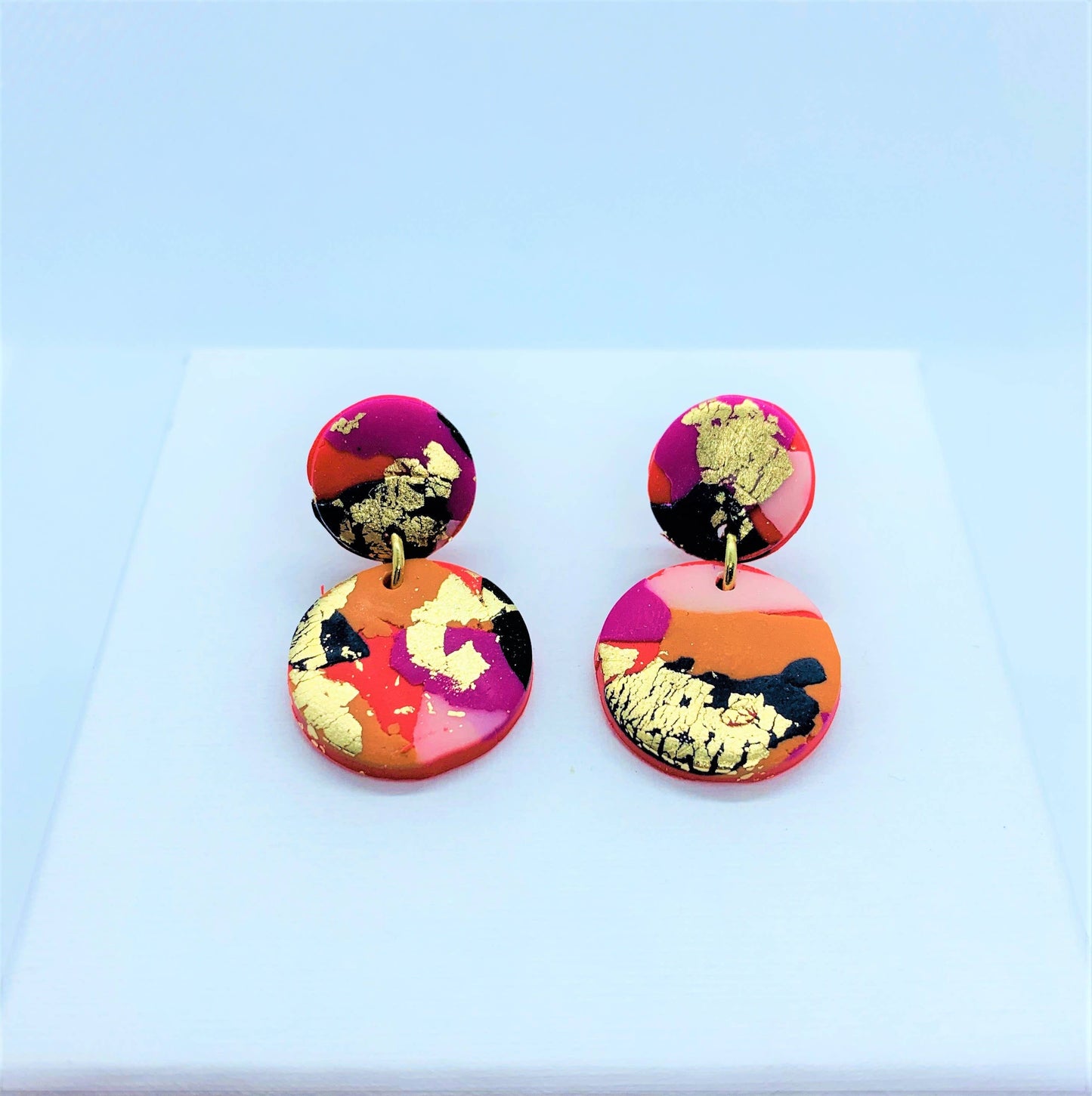 Close-up of Fire & Flood Mini Polymer Clay Earrings on a white background, showcasing unique design and texture.