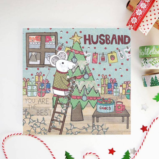 Husband Christmas Card. A Christmas card featuring Daddy Mouse wearing his festive sweater, playfully adorning the Christmas tree in an illustrated holiday setting.