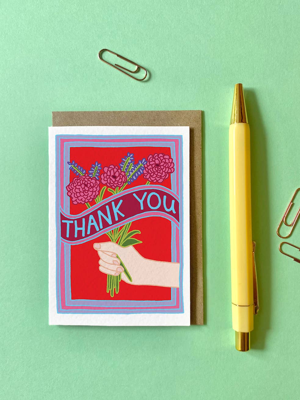 A7 'Thank You' mini card featuring a white hand and colourful flowers, with a Kraft envelope.