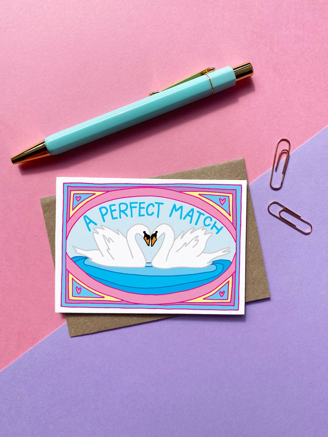 A PERFECT MATCH written on the card in blue caps. With a pair of white swans, head to head. Mini Card.