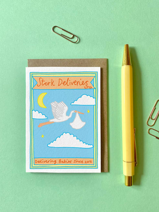 Stork Deliveries New Baby Greeting A7 Mini Card. Featuring a stork delivering a baby and the words Stork Deliveries LTD across the top and Delivering babies since 2016 at the bottom of the card.