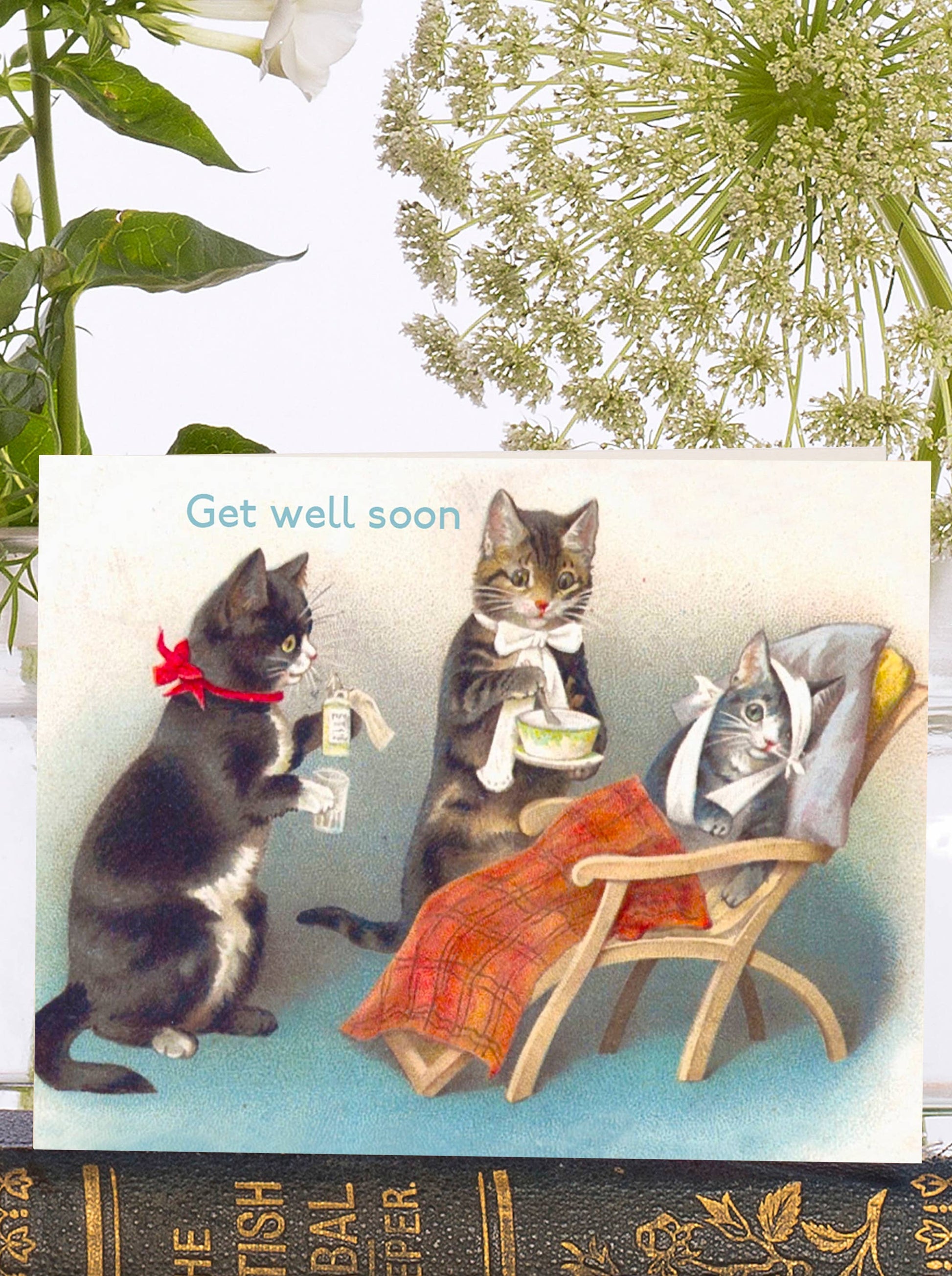 Make your loved ones smile with this adorable vintage get well mini card, featuring the cutest kittens playing nurse to their bandaged friend. Show them they're on your mind! With the words Get Well soon at the top of the card.